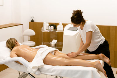 High angle view of young woman lying on sofa