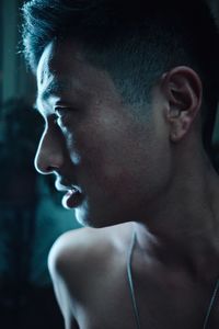 Close-up portrait of shirtless man