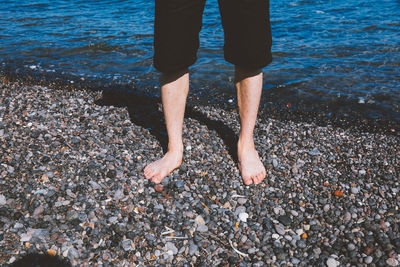 Low section of woman standing on beach