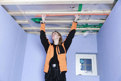 Young woman renovating house