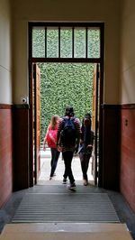 Rear view of people walking in corridor