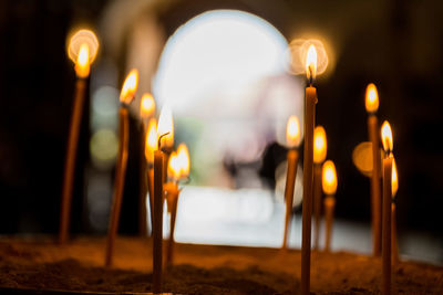 Close-up of illuminated candles in temple