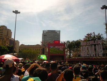 People on street in city against sky