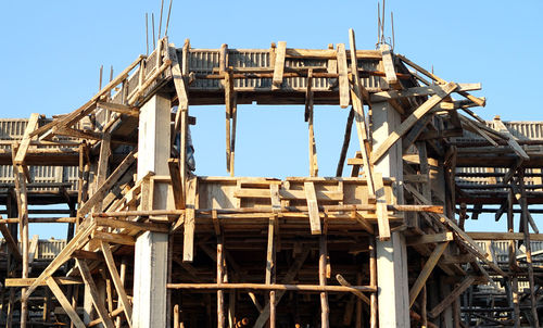 Low angle view of construction site against sky wood frame for concrete building house