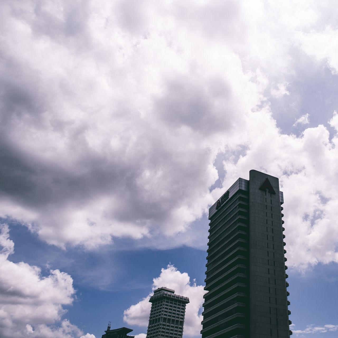 building exterior, architecture, skyscraper, built structure, sky, city, modern, cloud - sky, low angle view, tall - high, office building, cloudy, tower, cloud, building, day, tall, cityscape, outdoors, no people