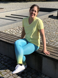 Portrait of a smiling young woman sitting on seat