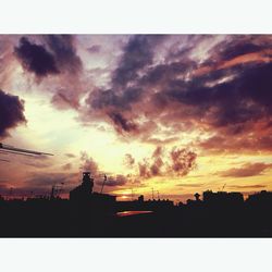 Silhouette of landscape against cloudy sky