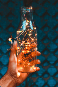 Close-up of hand holding glass light