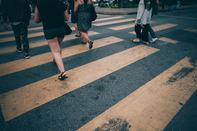 Low section of people walking on road