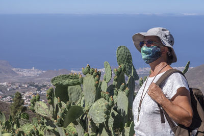 Side view of woman wearing sunglasses against sky