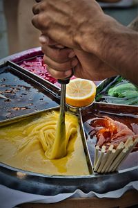 Close-up of man holding food on table