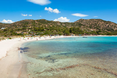 Scenic view of beach against blue sky