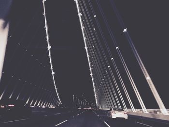 Low angle view of bridge against sky at night