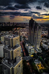 High angle view of illuminated cityscape against sky during sunset