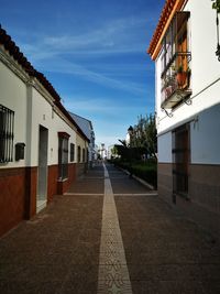 Street amidst buildings against sky