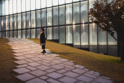 Full length of woman standing by railing