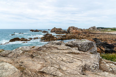 Rocks on beach against sky