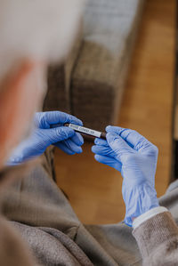 High angle view of doctor holding test tube with text