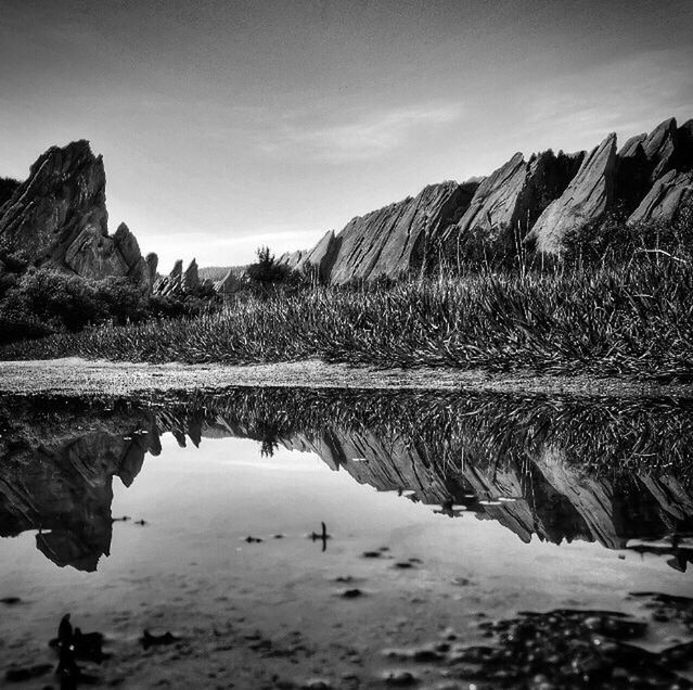 tranquil scene, tranquility, mountain, scenics, water, sky, reflection, beauty in nature, nature, landscape, lake, rock formation, non-urban scene, mountain range, rock - object, physical geography, geology, outdoors, river, idyllic