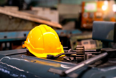 Yellow helmet and industrial equipment and metal.