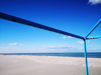 Scenic view of beach against blue sky