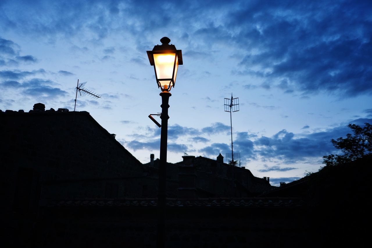 sky, cloud - sky, street light, architecture, built structure, low angle view, building exterior, lighting equipment, silhouette, street, dusk, nature, no people, outdoors, building, technology, illuminated, blue, electricity, gas light, electric lamp