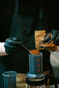 Midsection of person preparing food in kitchen