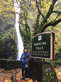 Portrait of woman standing against horsetail falls