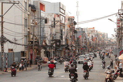 People and vehicles on street in city