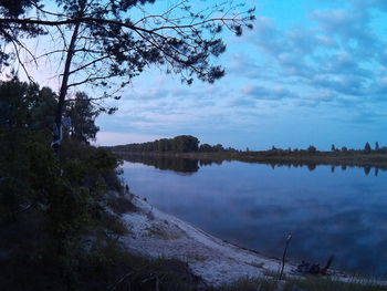 Scenic view of lake against cloudy sky