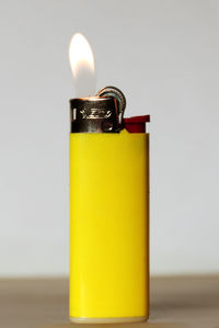 Close-up of yellow candle on table