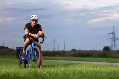 Man riding bicycle on field