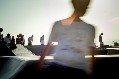 Blurred motion of man at skateboard park against sky
