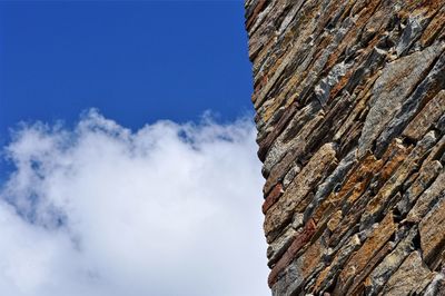 Low angle view of wall against blue sky