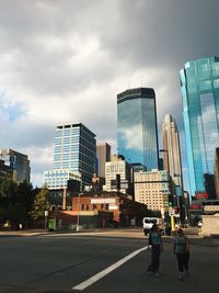 Man in city against sky