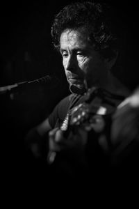 Close-up of man playing guitar