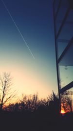 Low angle view of silhouette trees against sky during sunset