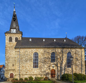 Exterior of historic building against blue sky