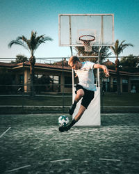 Man playing with basketball hoop