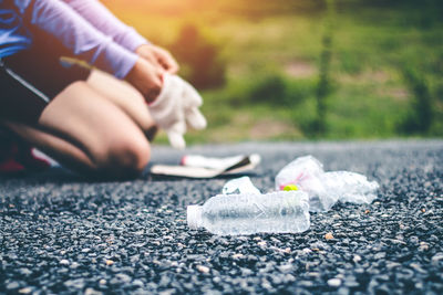 Close-up of man skateboarding on road in city