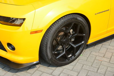 Close-up of yellow car parked on street