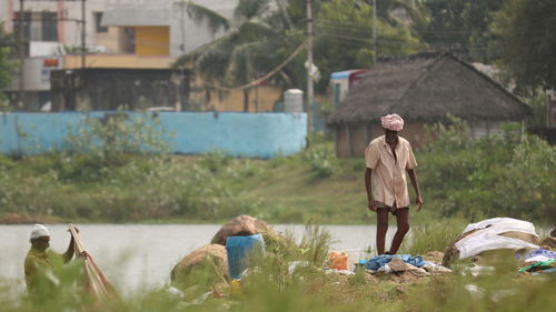 Working people by river against townscape