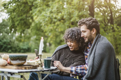 Young couple holding hands on mobile phone