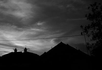 Low angle view of silhouette building against sky