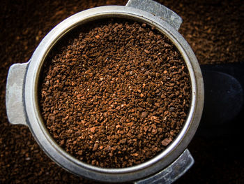Directly above shot of crushed coffee beans in container