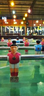 Close-up of figurine by swimming pool