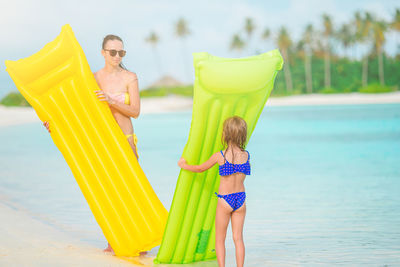 Rear view of women on beach