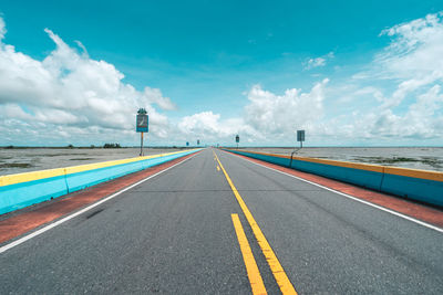 Road by sea against sky