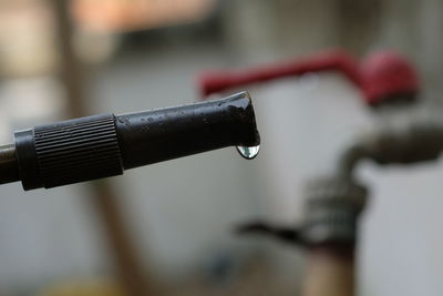 Close-up of faucet in black and white wall