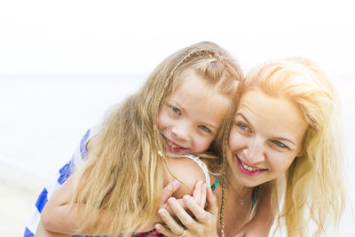 Happy mother with girl at beach